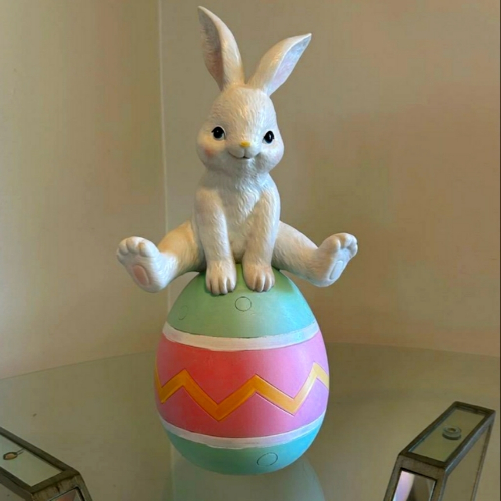 Easter bunny on top of an Easter egg
